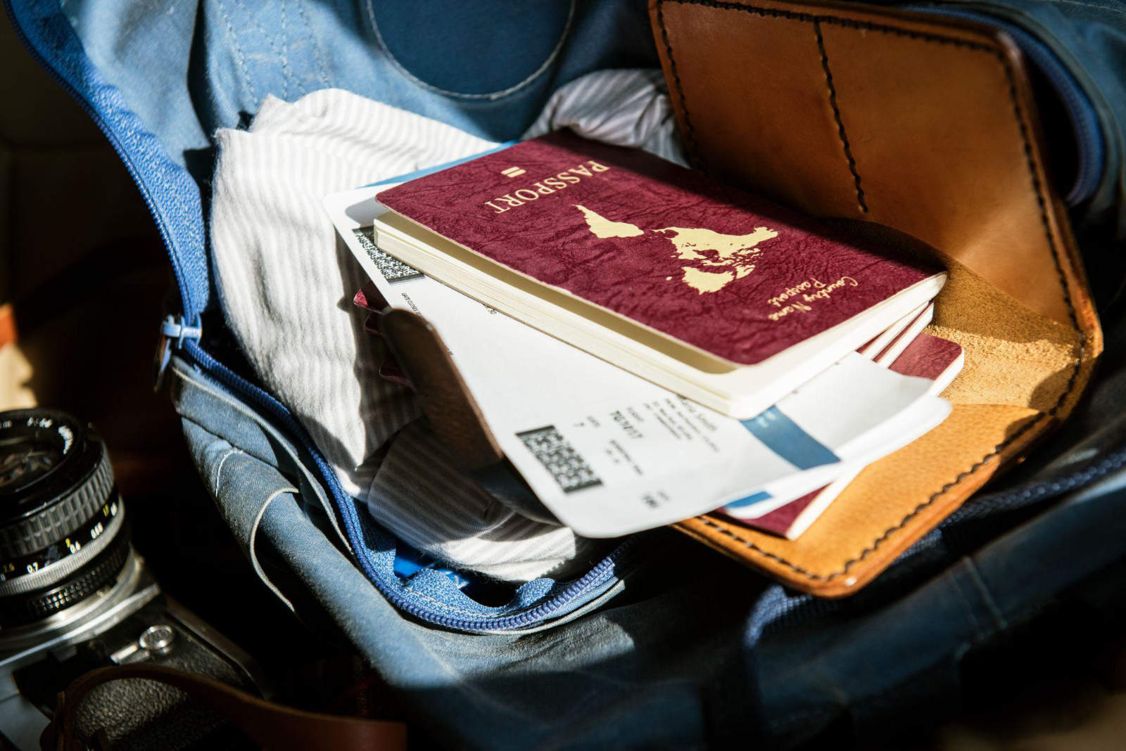 A open bag containing important personal documents, passports, and travel papers gathered during an estate cleanout.
