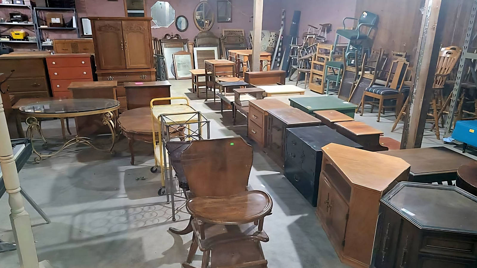 Warehouse filled with donated wooden furniture, cabinets, and home fixtures ready for reuse.