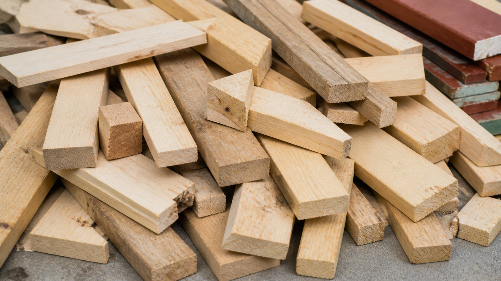 Pile of cut scrap wood 2x4s and untreated lumber ready for sorting or removal.